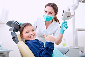 Boulder general dentist smiles with pediatric patient