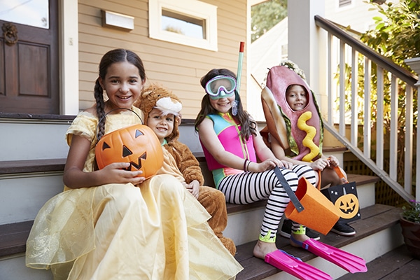 Children hold Halloween candy in costumes in Boulder, colorado