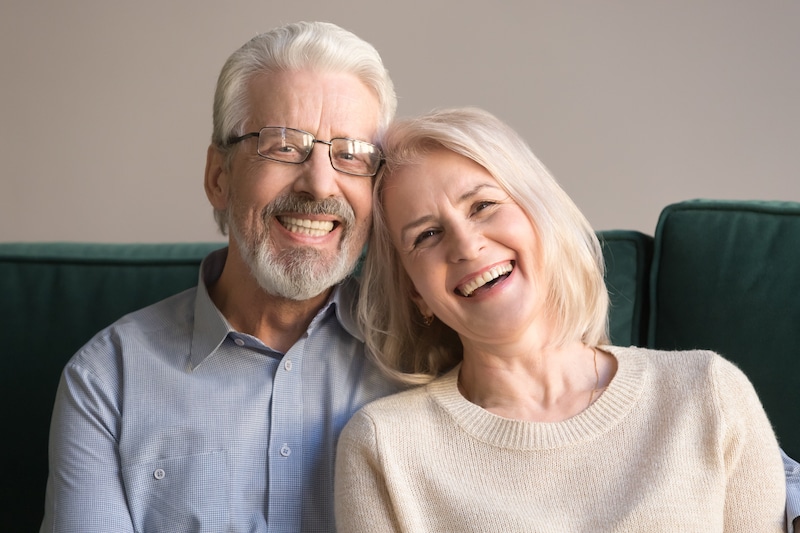 smiling couple wearing dentures
