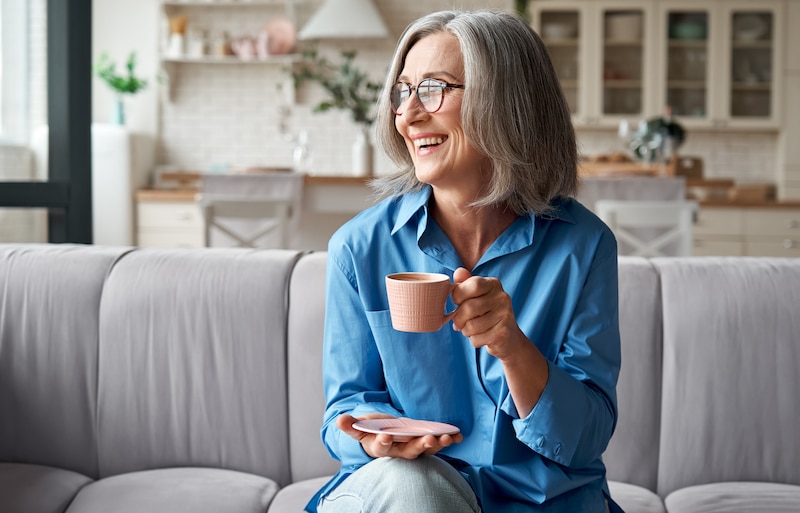 Woman with dentures drinking coffee
