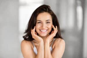 Woman with white, beautiful smile from porcelain veneers in Boulder, CO