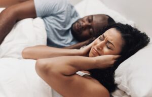 Woman struggling to sleep next to partner with sleep apnea in Boulder CO